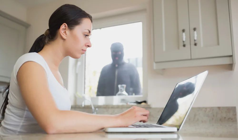 Young woman seeing reflection of robber