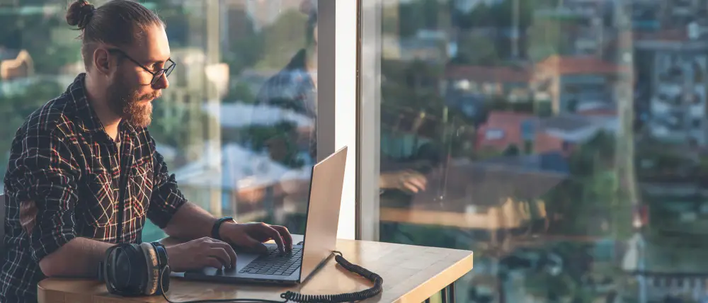 Man working on a laptop knowing his company has Remote Workforce Security