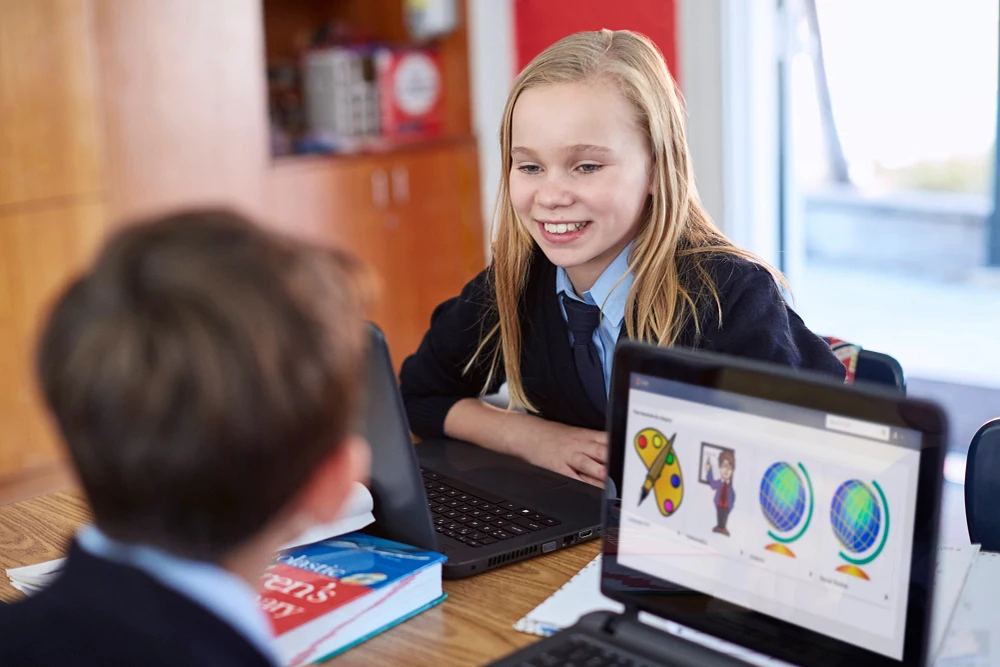 2 students looking at each other smiling